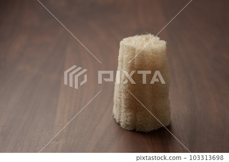 Organic loofah bath scrub on walnut table Organic loofah bath scrub on walnut table 103313698