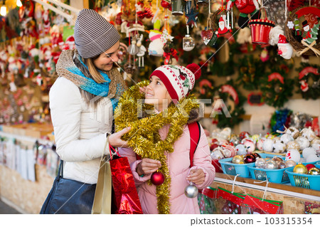 Positive mother with small daughter in market Positive mother with small daughter in market 103315354