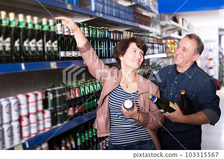 Couple shooses beer in store Couple shooses beer in store 103315567