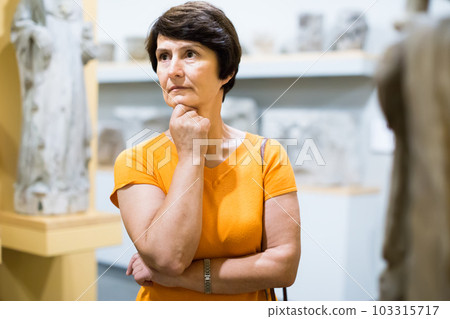 Portrait of mature woman visiting museum of ancient sculpture 103315717