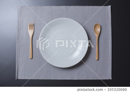 White plate and fork and spoon 103320080