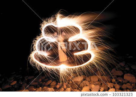 A child drawing "poop" with hand-held fireworks 103321323
