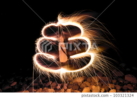 Child drawing "poop" with hand-held fireworks 103321324