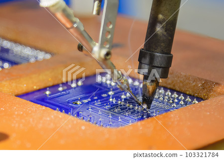 The automatic soldering machine operation with PCB board. The automatic soldering machine operation with PCB board. 103321784