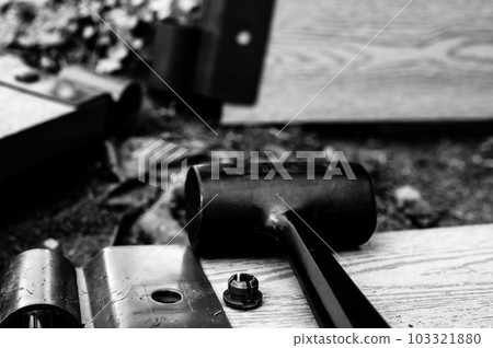 Assembling a raised bed garden panel with plastic connectors using a rubber mallet. Assembling a raised bed garden panel with plastic connectors using a rubber mallet. 103321880
