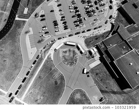 Drone overhead aerial view of a school letting out students at the end of the day. Drone overhead aerial view of a school letting out students at the end of the day. 103321959