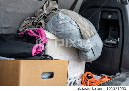 Cloths and material bagged and boxed for donation in the back of a vehicle. Cloths and material bagged and boxed for donation in the back of a vehicle. 103321960