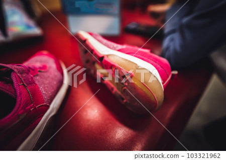 pair of worn out children's sneakers with scuffs damaged straps. pair of worn out children's sneakers with scuffs damaged straps. 103321962