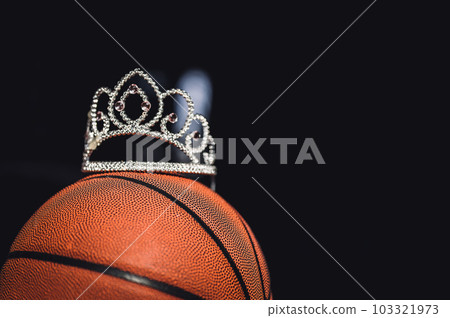 Basketball, tiara, and blank bracket signifying a Cinderella season. 103321973