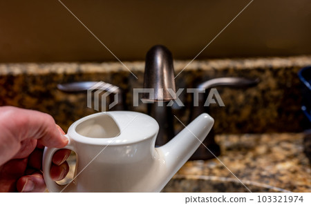 Improperly filling a neti pot with nonsterile tap water. 103321974