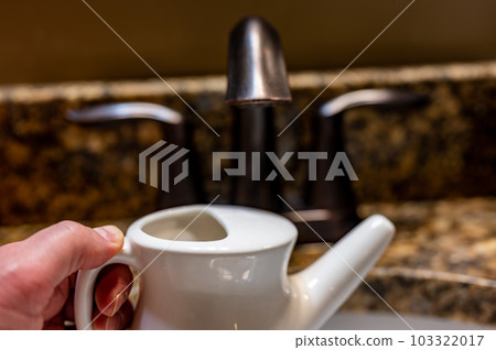 Improperly filling a neti pot with nonsterile tap water. 103322017