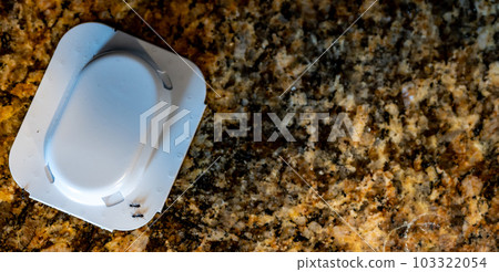Ant trap poison bate on a granite kitchen countertop 103322054