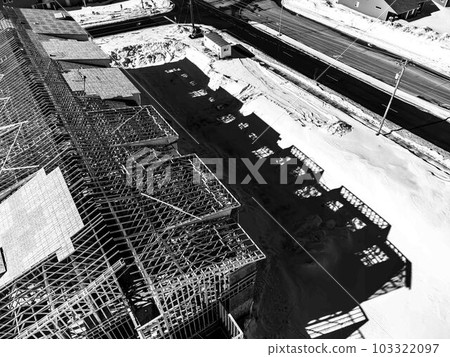Aerial drone view of a multifamily apartment complex under construction. Aerial drone view of a multifamily apartment complex under construction. 103322097