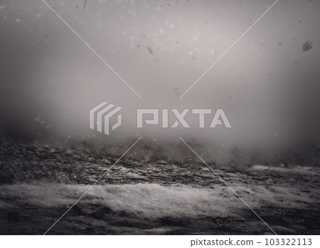Blowing snow and Focus stacked ground level view of ice accumulation on a sidewalk with blowing snow.  103322113