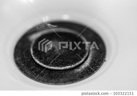 Selective focus on a closed bronze sink drain. Selective focus on a closed bronze sink drain. 103322151