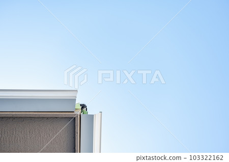 Metal gutters be installed on a residential buildings with two sections coming together for a 90 degree connection. Metal gutters be installed on a residential buildings with two sections coming together for a 90 degree connection. 103322162