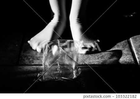 Focus on feet of a child standing on top of bubble wrap that has been popped. Focus on feet of a child standing on top of bubble wrap that has been popped. 103322182
