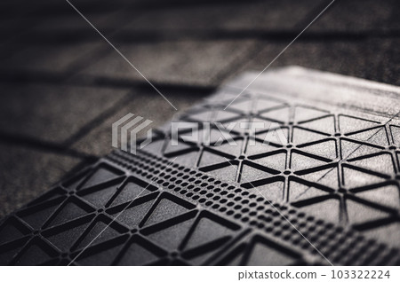 Underside of a synthetic roof shingle that is hail and wind resistant.  103322224