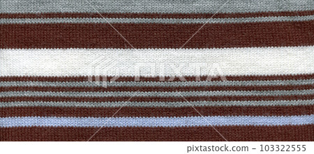 Handmade knitted fabric white brown and blue wool background texture 103322555
