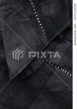 Sleeve detail of a black suede jacket with white contrast stitching Sleeve detail of a black suede jacket with white contrast stitching 103322694