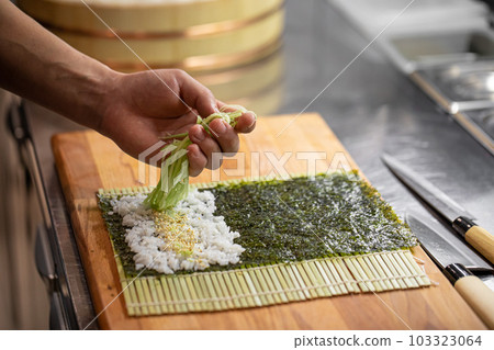 Sushi Chef Making Roll Sushi With Cucumber And Egg Stock Photo, Picture and  Royalty Free Image. Image 131623657.