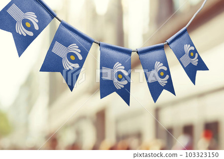 A garland of CIS national flags on an abstract blurred background 103323150