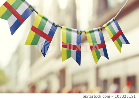 A garland of Central African Republic national flags on an abstract blurred background A garland of Central African Republic national flags on an abstract blurred background 103323151