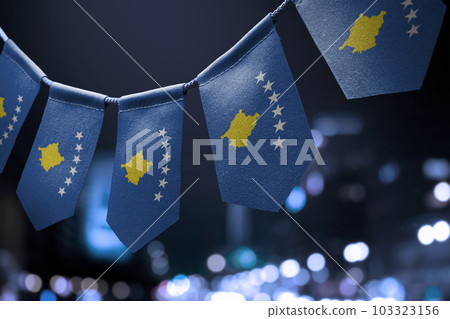 A garland of Kosovo national flags on an abstract blurred background 103323156