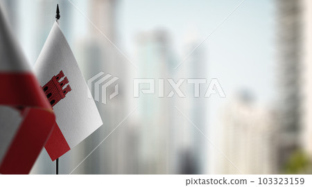 Small flags of the Gibraltar on an abstract blurry background 103323159