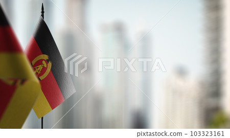 Small flags of the GDR on an abstract blurry background 103323161