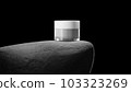 Jar with cream on big grey stone. 103323269