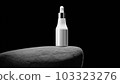 Bottle with pipet on big grey stone 103323276