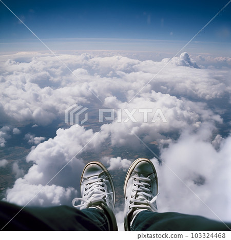 Photo taken down at high altitude above clouds while skydiving, photo shows the photographer's legs, sky below, an unusual angle, Photo taken down at high altitude above clouds while skydiving, photo shows the photographer's legs, sky below, an unusual angle, 103324468