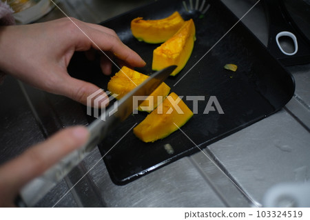 Pumpkin being cut Pumpkin being cut 103324519