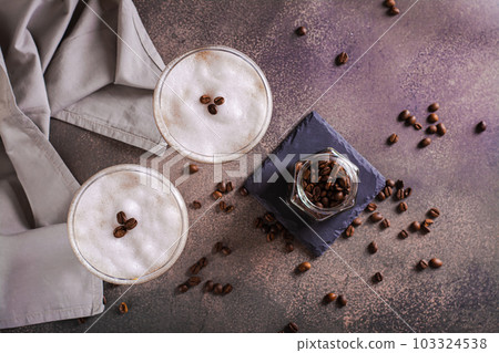 Cold martini espresso cocktail in glasses and coffee beans on the table top view Cold martini espresso cocktail in glasses and coffee beans on the table top view 103324538