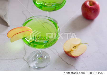 Refreshing apple martini with fruit in glasses on the table 103324569