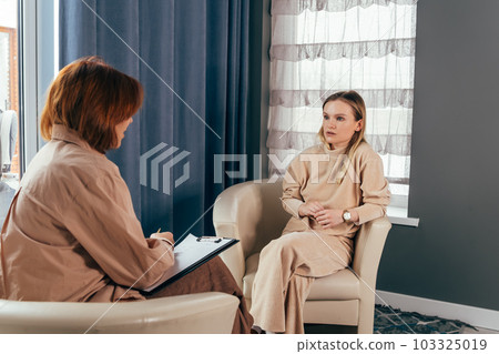 Young woman talking about her mental health problems. 103325019