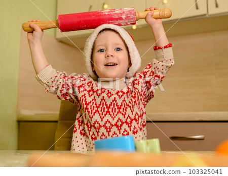 Kids cooking Christmas cookies at home. Xmas baking. Santa helper. 103325041
