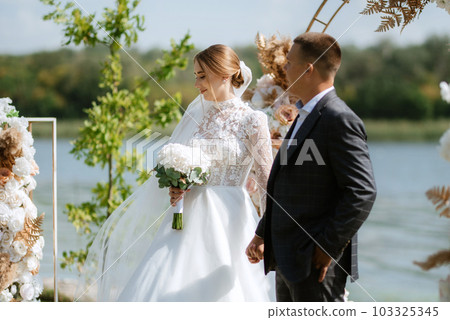 wedding ceremony of the newlyweds on the pier 103325345