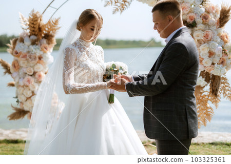 wedding ceremony of the newlyweds on the pier 103325361