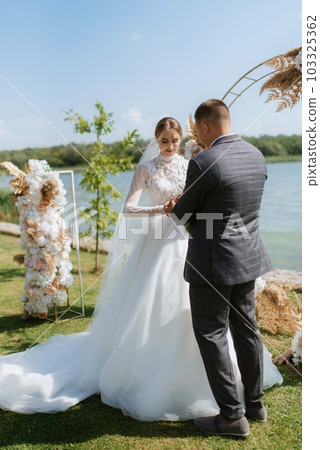 wedding ceremony of the newlyweds on the pier 103325362