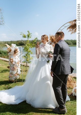 wedding ceremony of the newlyweds on the pier 103325364