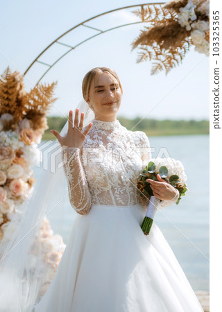 wedding ceremony of the newlyweds on the pier 103325365