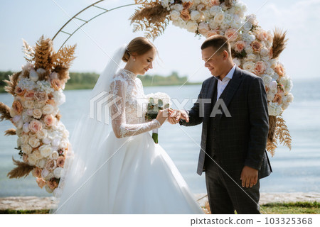 wedding ceremony of the newlyweds on the pier 103325368