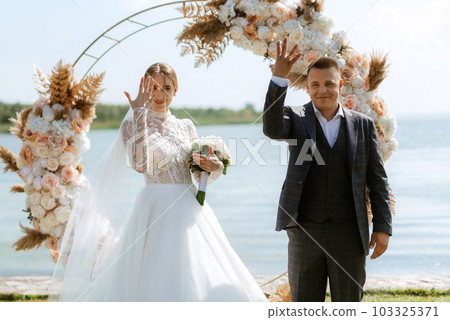 wedding ceremony of the newlyweds on the pier 103325371