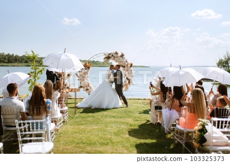 wedding ceremony of the newlyweds on the pier 103325373