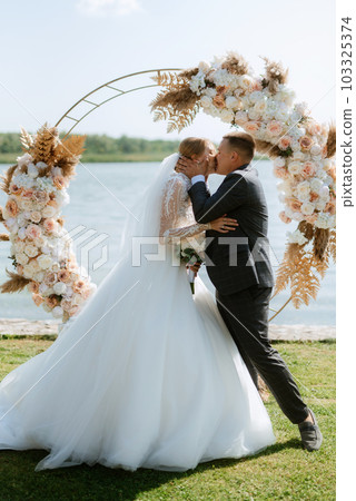 wedding ceremony of the newlyweds on the pier 103325374
