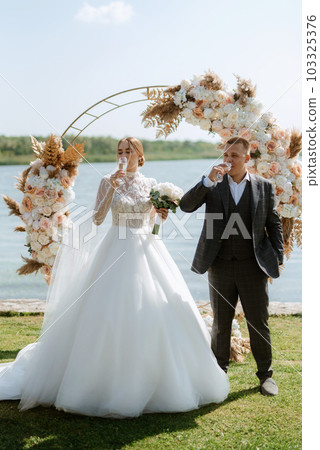 wedding ceremony of the newlyweds on the pier 103325376