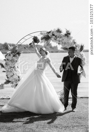 wedding ceremony of the newlyweds on the pier 103325377