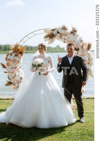 wedding ceremony of the newlyweds on the pier 103325378